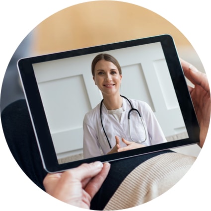 Someone having a virtual office visit with a doctor using a tablet device