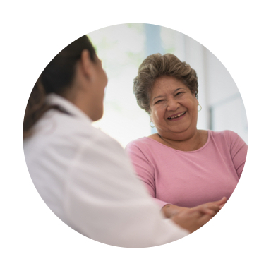 Image of woman laughing while visiting with care giver