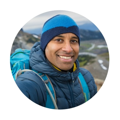 Image of man backpacking in the mountains smiling