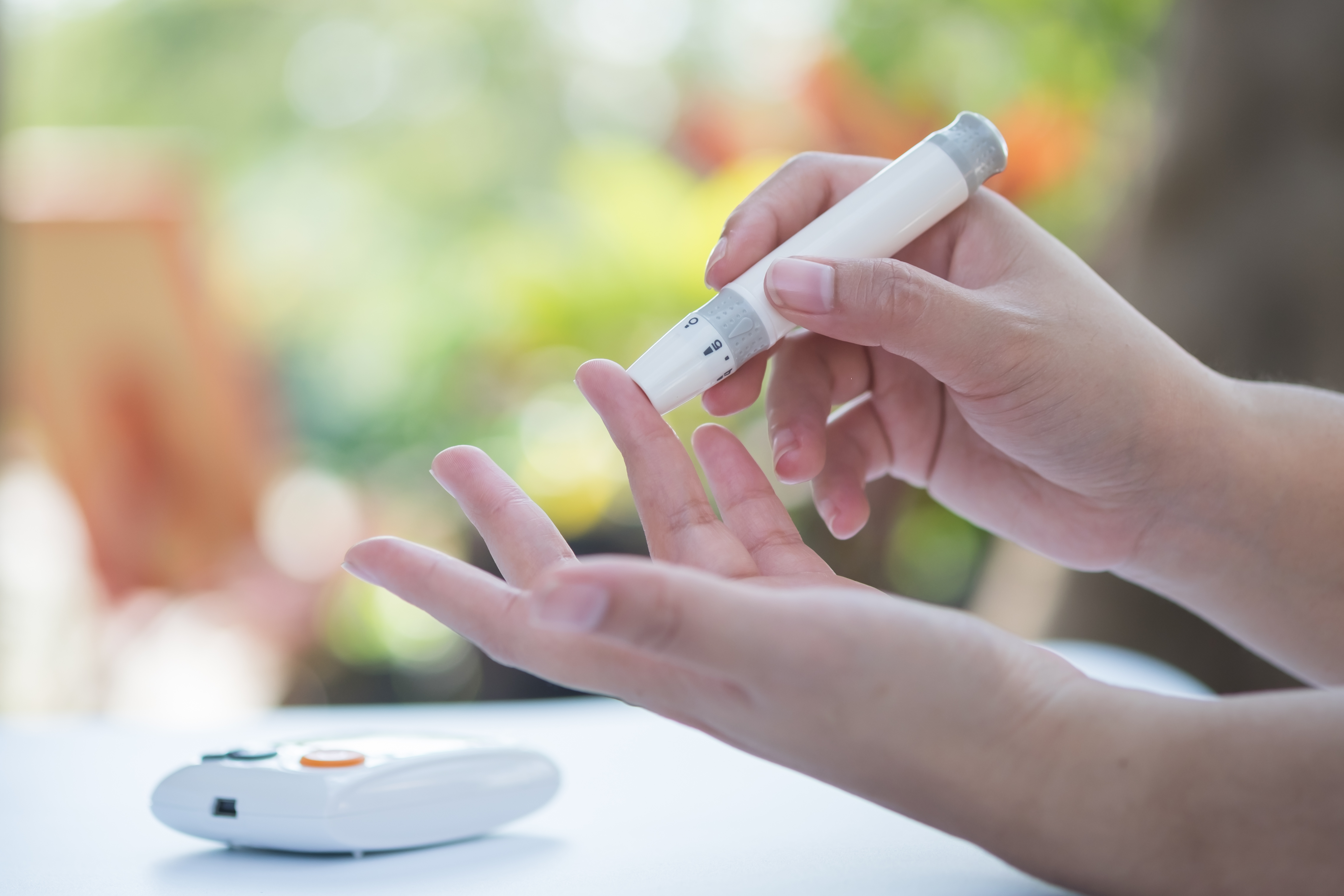 Young man using an electronic testing meter for glucose testing