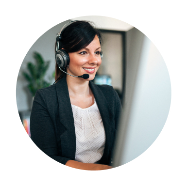 Smiling woman wearing headset while looking at computer screen