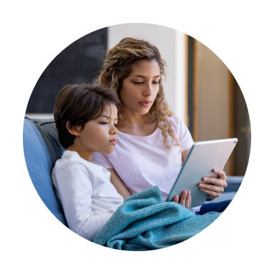 Woman reading tablet to child on lap