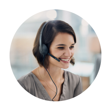 Image of smiling woman in a gray blouse talking on a headset