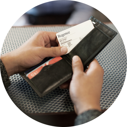 A person pulls a Regence card out of an open wallet