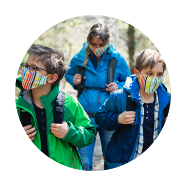 3 women hiking and wearing colorful face mask