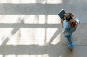 Image medical professional walking with tablet device