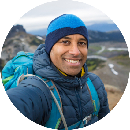 Man in hiking gear with mountains in the background