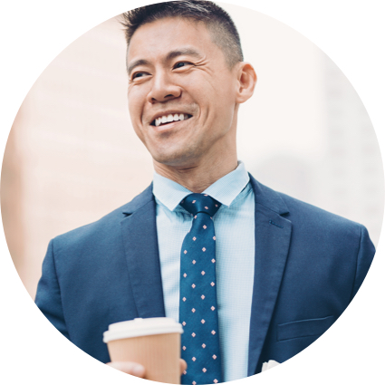 Asian man in suit holding coffee